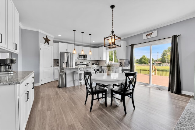 343 Hidden Riv E, Holly, MI 48442 - dining area featuring crown molding, light wood-style flooring, recessed lighting, and a chandelier