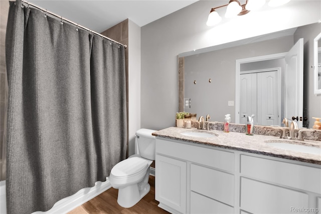 343 Hidden Riv E, Holly, MI 48442 - full bathroom with double vanity, wood finished floors, and shower / tub combo with curtain