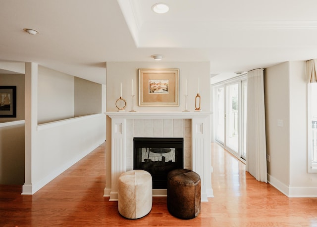 706 N Dockside Cir, Suttons Bay, MI 49682 - living area with a tile fireplace, light wood-type flooring, a raised ceiling, and recessed lighting