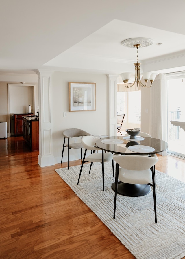 706 N Dockside Cir, Suttons Bay, MI 49682 - dining area featuring wood finished floors, a chandelier, and radiator heating unit