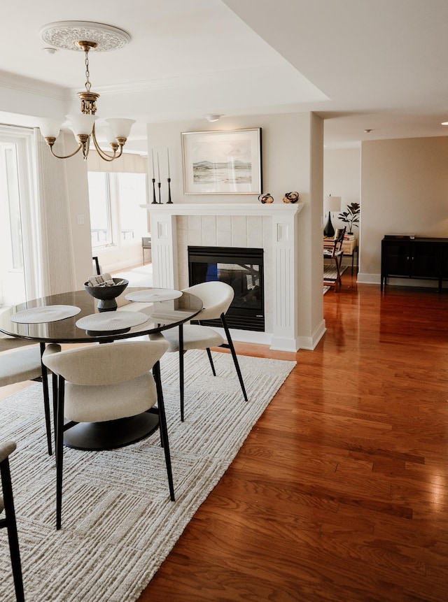 706 N Dockside Cir, Suttons Bay, MI 49682 - dining area with wood finished floors, a fireplace, and a chandelier