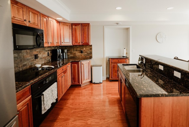 706 N Dockside Cir, Suttons Bay, MI 49682 - kitchen with black appliances, decorative backsplash, ornamental molding, recessed lighting, and light wood finished floors