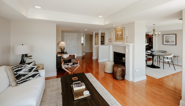 706 N Dockside Cir, Suttons Bay, MI 49682 - living area with a tray ceiling, wood finished floors, recessed lighting, crown molding, and a chandelier