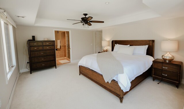 706 N Dockside Cir, Suttons Bay, MI 49682 - bedroom with a raised ceiling, light colored carpet, connected bathroom, crown molding, and a ceiling fan