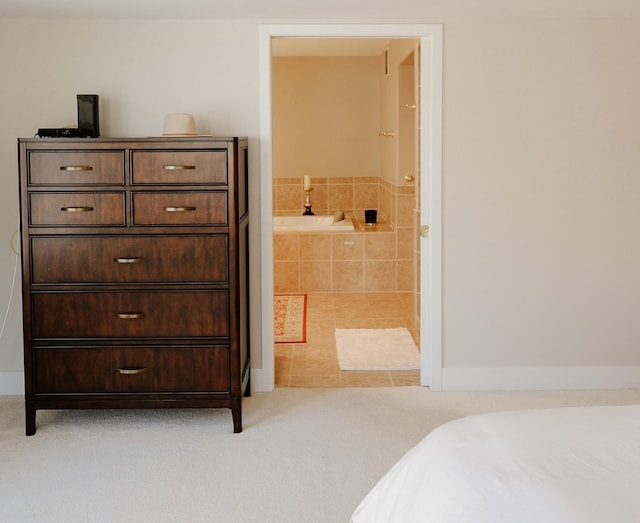 706 N Dockside Cir, Suttons Bay, MI 49682 - tiled bedroom with connected bathroom and carpet floors