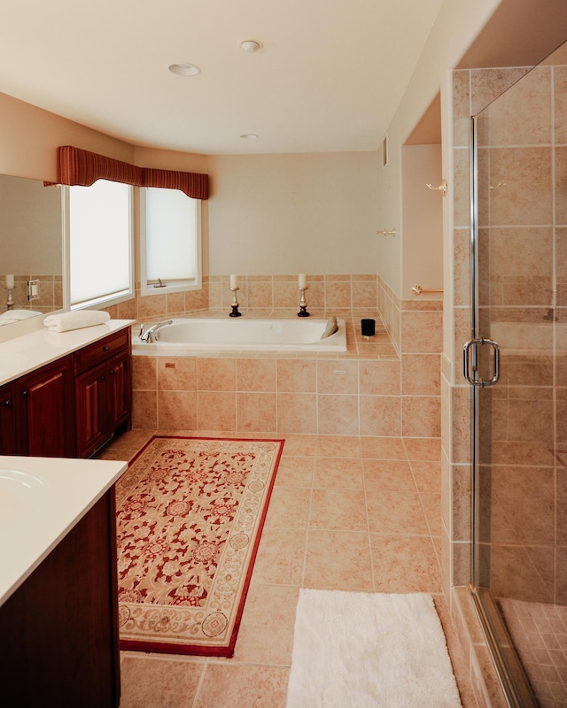 706 N Dockside Cir, Suttons Bay, MI 49682 - full bathroom with vanity, a garden tub, a stall shower, and tile patterned floors