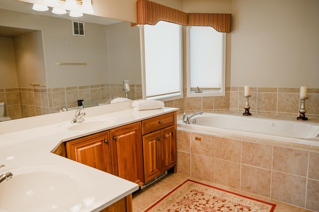 706 N Dockside Cir, Suttons Bay, MI 49682 - bathroom with double vanity, a garden tub, tile patterned floors, and healthy amount of natural light