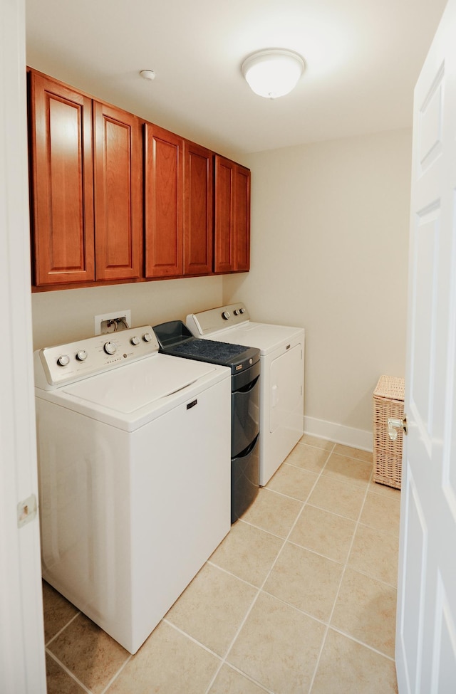706 N Dockside Cir, Suttons Bay, MI 49682 - washroom featuring separate washer and dryer, cabinet space, and light tile patterned floors