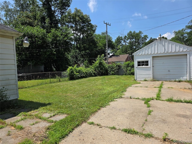 19351 Braile St, Detroit, MI 48219 - view of yard featuring concrete driveway, an outdoor structure, and a detached garage