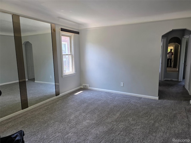 19351 Braile St, Detroit, MI 48219 - spare room with arched walkways and carpet floors