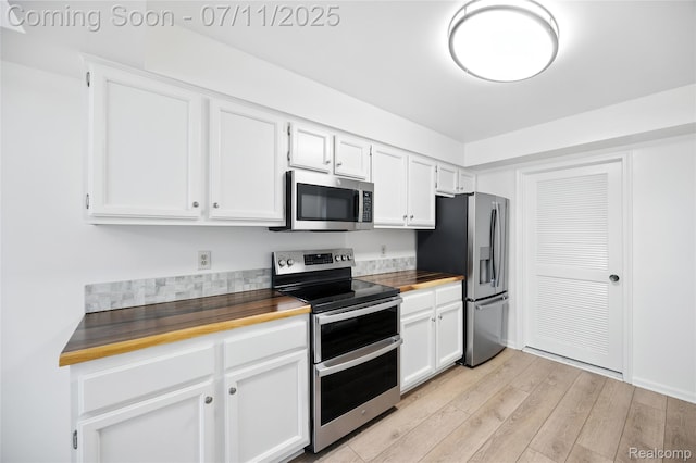 276 Meadow Bridge Dr, Rochester Hills, MI 48307 - kitchen with appliances with stainless steel finishes, light wood-style flooring, white cabinetry, and wooden counters