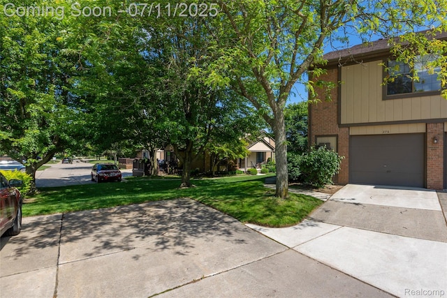 276 Meadow Bridge Dr, Rochester Hills, MI 48307 - view of property exterior with brick siding, driveway, a lawn, and a garage