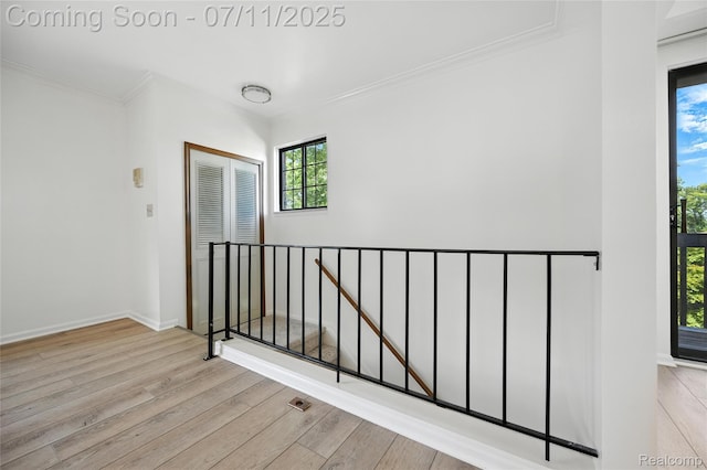 276 Meadow Bridge Dr, Rochester Hills, MI 48307 - hallway with wood finished floors, an upstairs landing, and ornamental molding