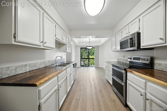 276 Meadow Bridge Dr, Rochester Hills, MI 48307 - kitchen with butcher block counters, appliances with stainless steel finishes, light wood finished floors, and white cabinets