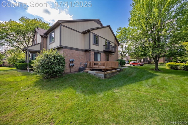 276 Meadow Bridge Dr, Rochester Hills, MI 48307 - back of house with a balcony, brick siding, and a yard