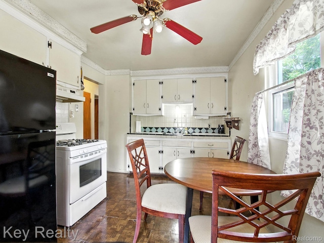 1225 S Annabelle St, Detroit, MI 48217 - kitchen with freestanding refrigerator, gas range gas stove, range hood, decorative backsplash, and a ceiling fan