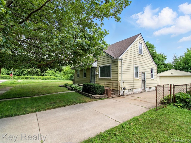 1225 S Annabelle St, Detroit, MI 48217 - view of home's exterior featuring a garage and a shingled roof