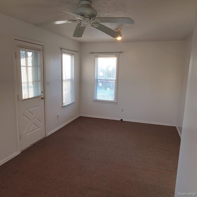 675 E Beverly Ave, Royal Oak, MI 48340 - spare room featuring dark carpet, healthy amount of natural light, and ceiling fan
