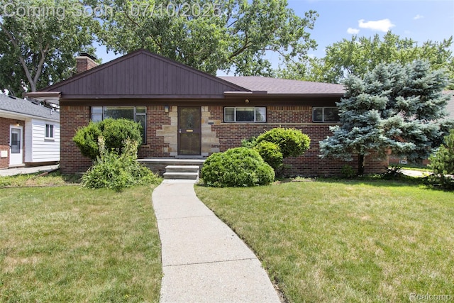 24280 Moritz St, Oak Park, MI 48237 - view of front of home featuring brick siding, a front lawn, and a chimney