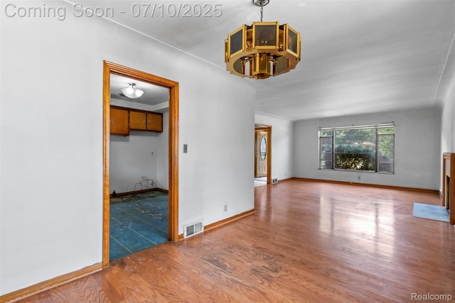 24280 Moritz St, Oak Park, MI 48237 - spare room featuring wood finished floors and a chandelier