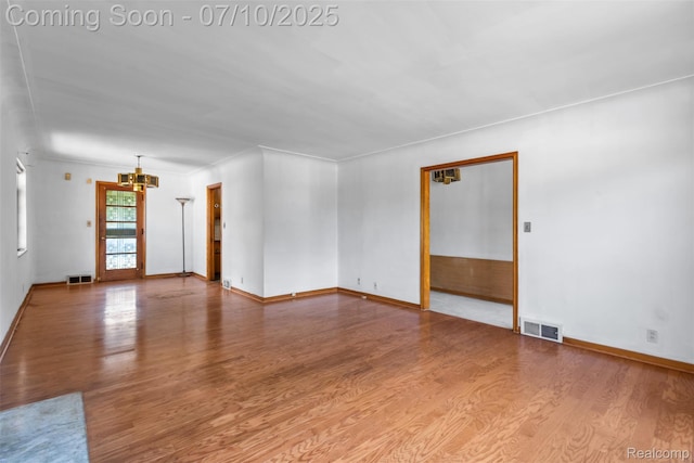 24280 Moritz St, Oak Park, MI 48237 - unfurnished room featuring a chandelier and wood finished floors