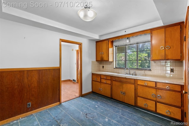 24280 Moritz St, Oak Park, MI 48237 - kitchen featuring brown cabinetry, backsplash, and dark tile patterned floors