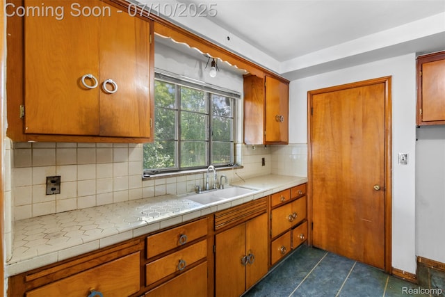 24280 Moritz St, Oak Park, MI 48237 - kitchen featuring brown cabinets, backsplash, and dark tile patterned flooring