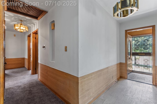 24280 Moritz St, Oak Park, MI 48237 - corridor featuring a chandelier, arched walkways, wainscoting, and wood finished floors