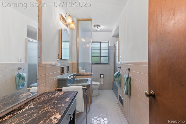 24280 Moritz St, Oak Park, MI 48237 - bathroom featuring tile walls, tile patterned floors, an enclosed shower, a wainscoted wall, and vanity