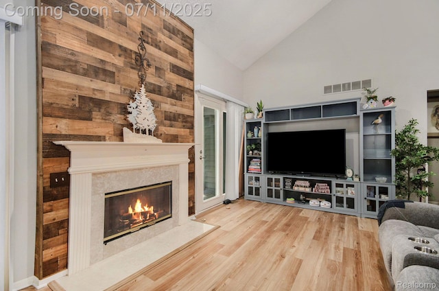 3787 Santa Fe Trl, Ann Arbor, MI 48108 - living area featuring wood finished floors, a fireplace, and high vaulted ceiling
