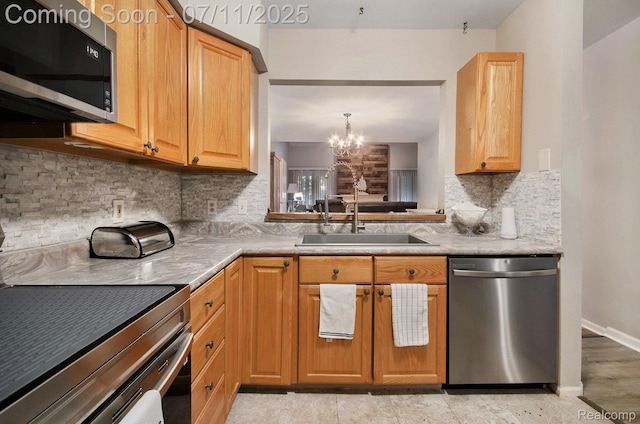 3787 Santa Fe Trl, Ann Arbor, MI 48108 - kitchen featuring stainless steel appliances, decorative backsplash, a chandelier, light countertops, and decorative light fixtures