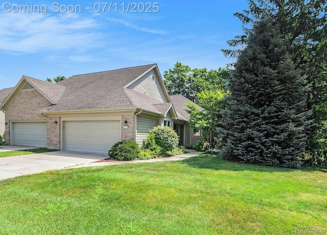 3787 Santa Fe Trl, Ann Arbor, MI 48108 - view of front of property featuring an attached garage, a front lawn, brick siding, driveway, and a shingled roof