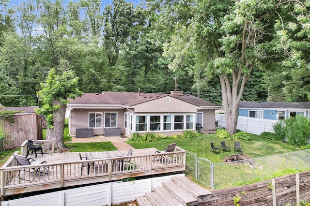 1890 Darwin Rd, Pinckney, MI 48169 - rear view of property featuring a deck, roof with shingles, and a fenced backyard