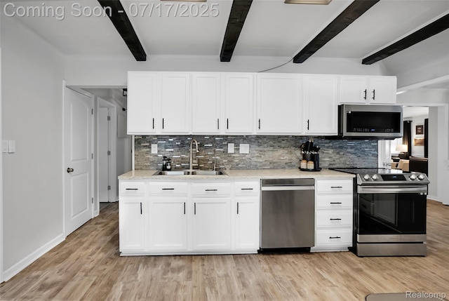 1890 Darwin Rd, Pinckney, MI 48169 - kitchen featuring beam ceiling, appliances with stainless steel finishes, decorative backsplash, and light wood finished floors