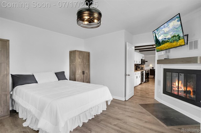 1890 Darwin Rd, Pinckney, MI 48169 - bedroom featuring wood finished floors and a glass covered fireplace