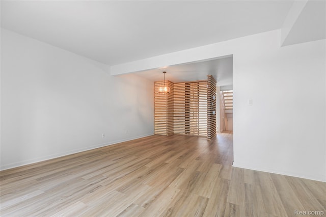 9671 Harbour Cove Ct, Ypsilanti, MI 48197 - spare room with a chandelier and light wood-type flooring