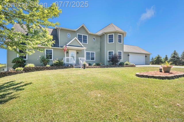 1090 E Jones Rd, Howell, MI 48855 - view of front of home featuring a front yard, a garage, and concrete driveway