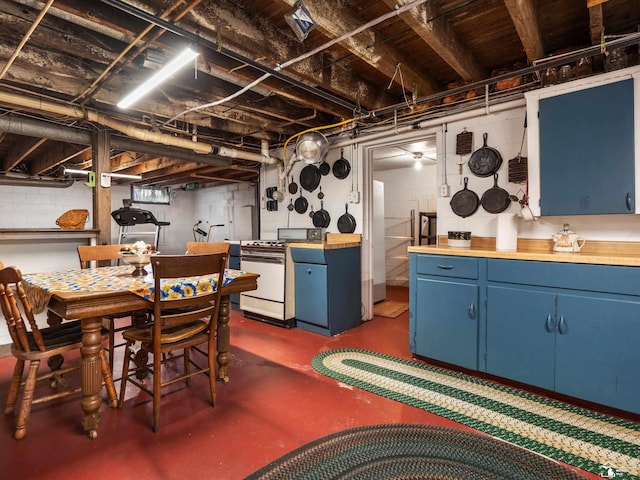 7393 Newport S Rd, Newport, MI 48166 - kitchen with blue cabinets, gas range gas stove, and concrete flooring
