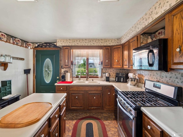 7393 Newport S Rd, Newport, MI 48166 - kitchen featuring gas stove, black microwave, light countertops, and brown cabinets