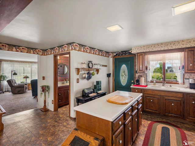 7393 Newport S Rd, Newport, MI 48166 - kitchen with healthy amount of natural light, light countertops, a kitchen island, and dark colored carpet