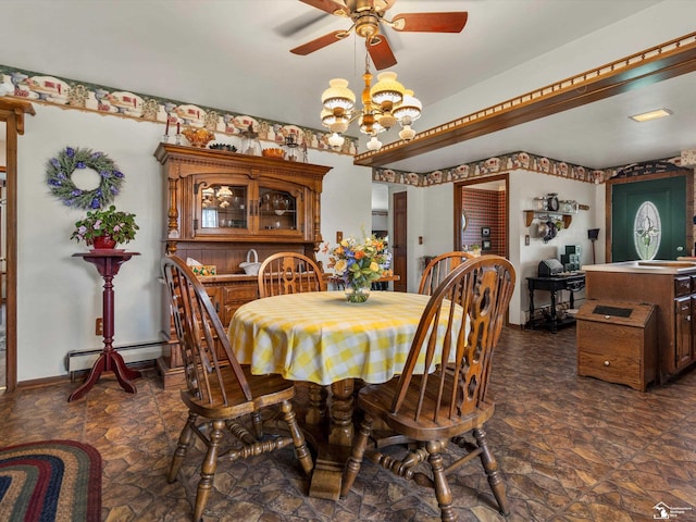 7393 Newport S Rd, Newport, MI 48166 - dining space featuring ceiling fan, dark stone finish flooring, a baseboard radiator, and a chandelier