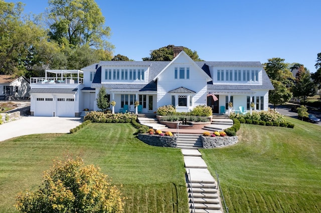 613 E Mitchell St, Petoskey, MI 49770 - view of front facade with french doors, a front yard, concrete driveway, a garage, and roof with shingles