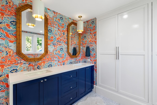 613 E Mitchell St, Petoskey, MI 49770 - full bathroom featuring wallpapered walls and double vanity