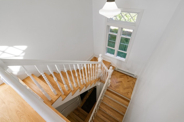 613 E Mitchell St, Petoskey, MI 49770 - stairway featuring baseboard heating