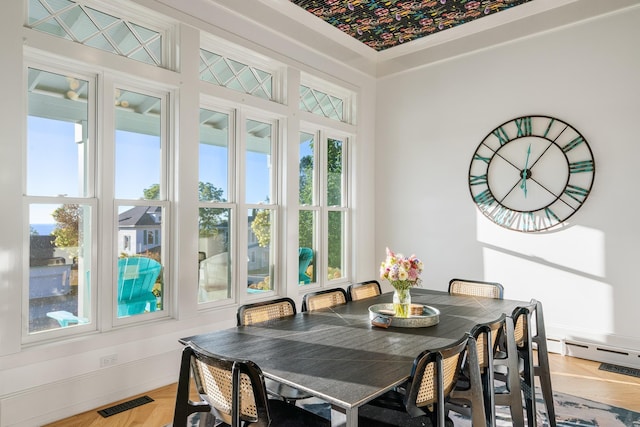 613 E Mitchell St, Petoskey, MI 49770 - dining area featuring healthy amount of natural light and a baseboard heating unit