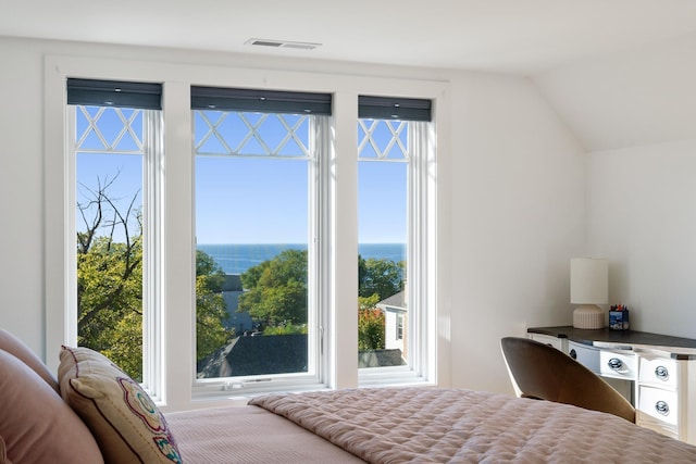613 E Mitchell St, Petoskey, MI 49770 - bedroom with multiple windows, vaulted ceiling, and a water view