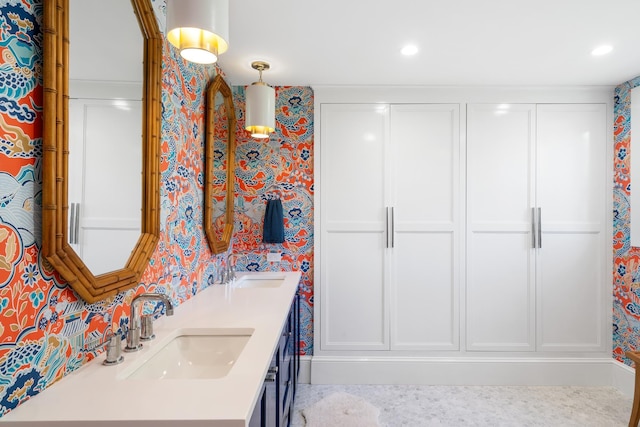 613 E Mitchell St, Petoskey, MI 49770 - full bath featuring wallpapered walls, double vanity, and recessed lighting