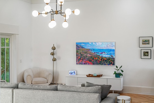 613 E Mitchell St, Petoskey, MI 49770 - living area featuring a chandelier, baseboard heating, and a towering ceiling