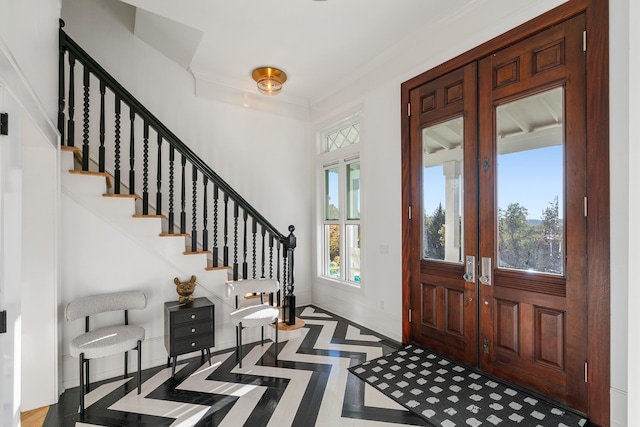 613 E Mitchell St, Petoskey, MI 49770 - entrance foyer with inlaid floor details, stairway, and ornamental molding