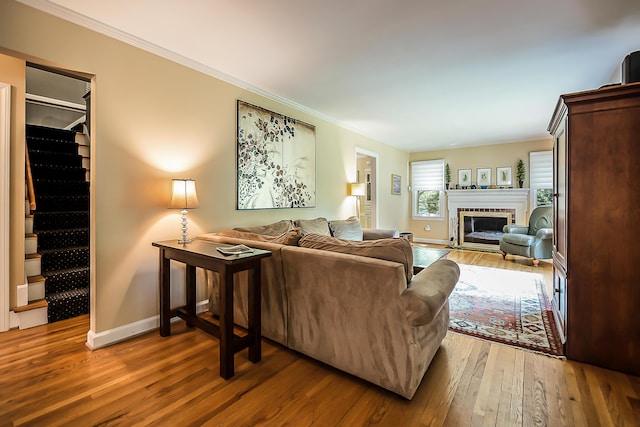 1925 Norway Rd, Ann Arbor, MI 48104 - living area with hardwood / wood-style floors, ornamental molding, a fireplace with flush hearth, and stairway